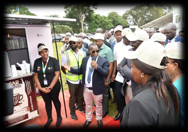 Officials gathered around Coffee on Wheels during the programme launch